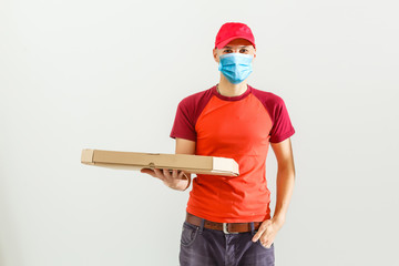 delivery man in protective mask with parcel post box isolated over white background.
