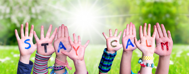 Children Hands Building Colorful English Word Stay Calm. Sunny Green Grass Meadow As Background