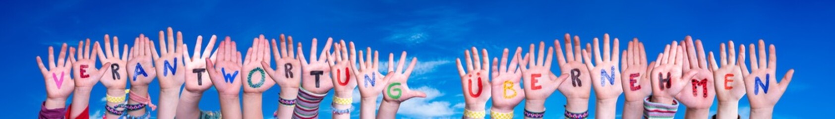 Children Hands Building Colorful German Word Verantwortung Uebernehmen Mean Take Resposibility. Blue Sky As Background