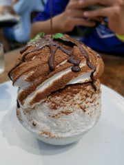 Korean Dessert - Chocolate bingsu or ice snow flake with fresh milk  on white  plate