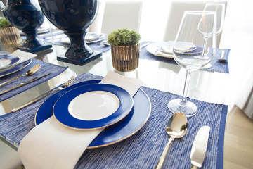 Dishes and the silverware on the dining table 