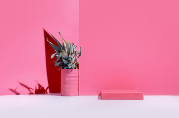 A bright, surreal pineapple stands on a table against a pastel pink wall. The concept of decor, new fashion, fresh ideas.