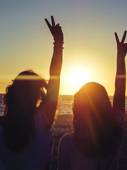 Silhouette of two girls on a beach