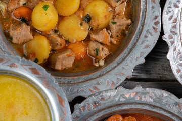 Eid Mubarak Traditional Ramadan Iftar dinner. Assorted tasty food in authentic rustic dishes on wooden table background.
