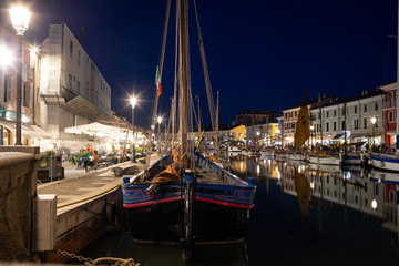  Night view of the port canal designed by Leonardo da Vinci and old town of Cesenatico on the...