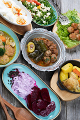 Eid Mubarak Traditional Ramadan Iftar dinner. Assorted tasty food in authentic rustic dishes on wooden table background.