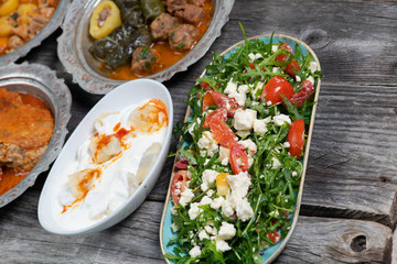 Eid Mubarak Traditional Ramadan Iftar dinner. Assorted tasty food in authentic rustic dishes on wooden table background.