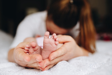 a mother holding her baby's feet