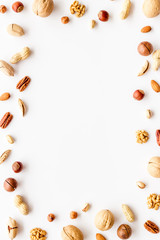 Nuts background - healthy snacks concept - on white table top-down frame copy space