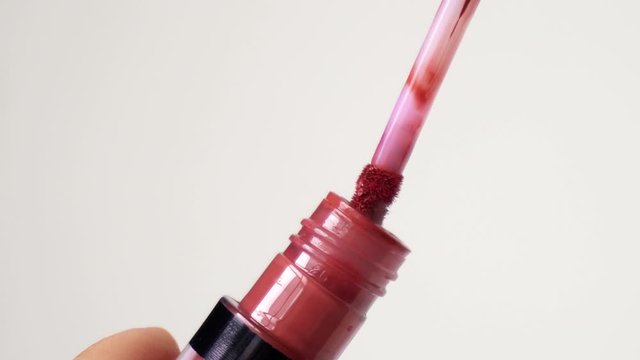 Liquid lip balm with a brush