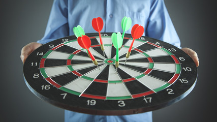 Fototapeta premium Businessman holding dart board with arrows. Target, Business, Success