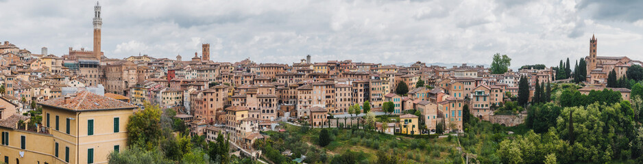 Fototapeta na wymiar Panorama of Siena, cityscape, a beautiful medieval town in Tuscany, with view of the Dome Bell Tower of Siena Cathedral, landmark Mangia Tower and Basilica of San Domenico, Italy