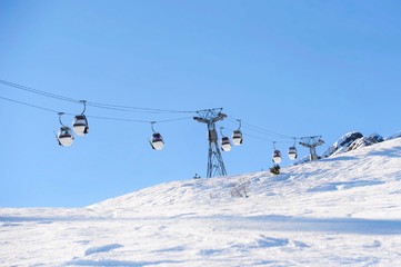 Fototapeta na wymiar Winter scenery with ski lifts on the slope 