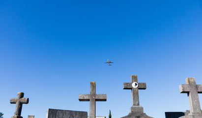 An airplane flies over the crosses in the Bilbao cemetery, Spain