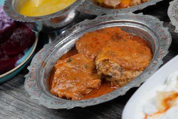 Eid Mubarak Traditional Ramadan Iftar dinner. Assorted tasty food in authentic rustic dishes on wooden table background.