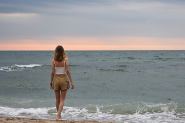 Fototapeta na wymiar young woman on the background of the sea