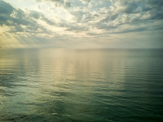 Aerial view of a Sunrise sky background. Aerial Dramatic gold sunrise with morning sky clouds over the sea. Stunning sky clouds in the sunrise. Aerial photography.