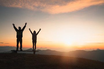 Man rise hand up on top of mountain and sunset,  Freedom and travel adventure concept. Religious...
