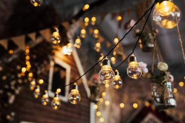 Beautiful retro luxury light lamps, decor glowing. Garland light bulbs. Decorative in home, select...