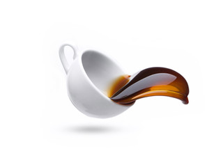 coffee cup falls to the floor, the coffee is poured, splashed on a white background