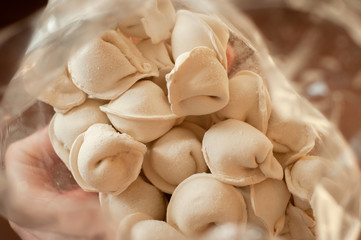 Frozen dumplings close-up in a transparent package.