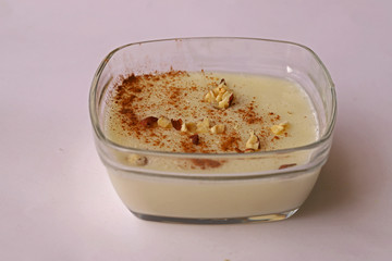 custard made with milk, cinnamon and hazelnut crumbs on it.