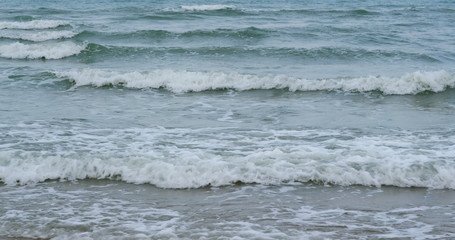 Turquiose sea waves on beach