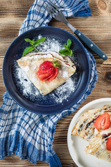 Polish pancakes with jam, cheese and strawberries.