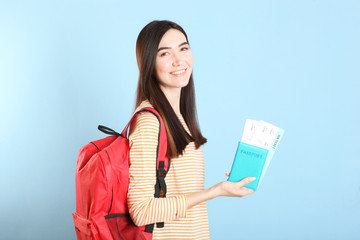 Beautiful young smiling girl holds tickets for travel. Rest, travel, tour.