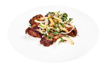 portion of pork shashlik on white plate isolated