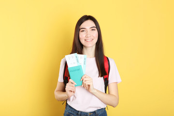 Fototapeta premium Beautiful young smiling girl holds tickets for travel. Rest, travel, tour.