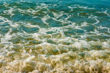 Blue sea water with white foam for background, nature background concept