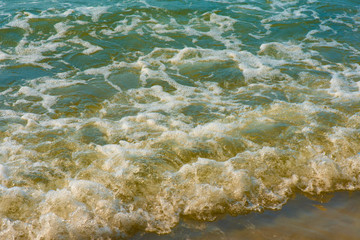 Blue sea water with white foam for background, nature background concept