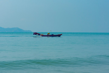Blue sea water with  Folk fishing boat for background, nature background concept.