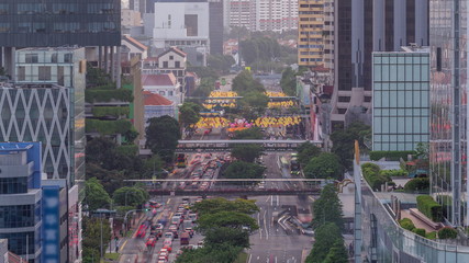 Fototapeta premium Traffic with cars on a street and urban scene in the central district of Singapore timelapse