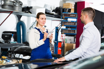 Woman mechanic with male client