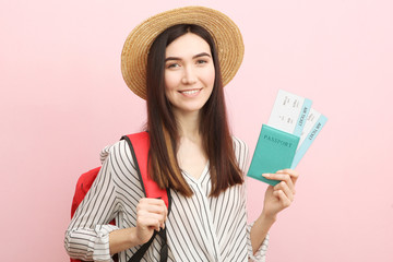 Beautiful young smiling girl holds tickets for travel. Rest, travel, tour.