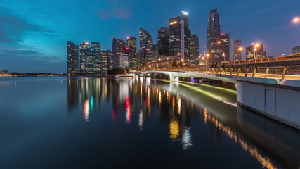 Fototapeta na wymiar Esplanade bridge and downtown core skyscrapers in the background Singapore night to day timelapse
