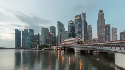 Naklejka premium Esplanade bridge and downtown core skyscrapers in the background Singapore night to day timelapse