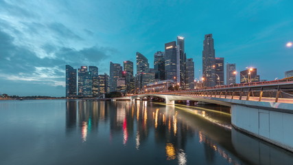 Naklejka premium Esplanade bridge and downtown core skyscrapers in the background Singapore night to day timelapse