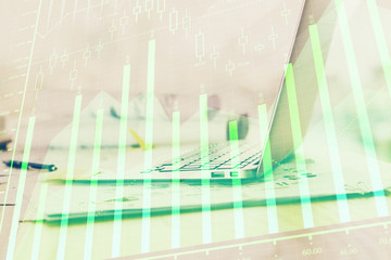 Forex graph hologram on table with computer background. Multi exposure. Concept of financial markets.