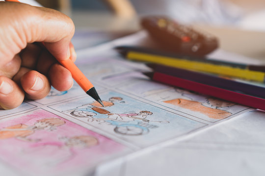Video Pre-production for film movie storyboard concept : Hands drawing story board animation comic carton, design creative scene layout at studio. Behind process work before production films shot
