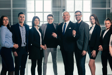 Fototapeta premium group of happy business people standing in the office lobby