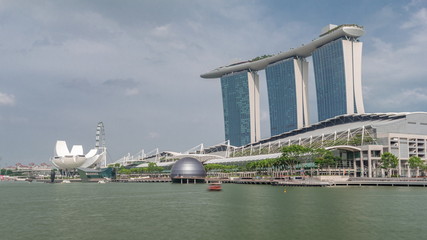 Fototapeta na wymiar Fifty-five storeys high Marina Bay Sands Hotel dominates the skyline at Marina Bay in Singapore timelapse hyperlapse.