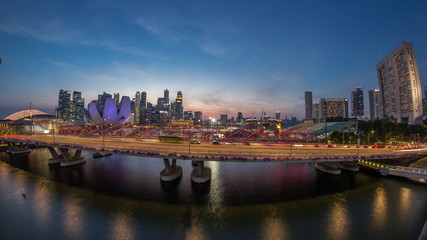 Obraz premium Aerial view over Helix Bridge and Bayfront Avenue with traffic day to night timelapse at Marina Bay, Singapore