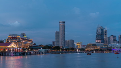 City skyline with skyscrapera and Esplanade Theatres on the Bay in Singapore at dusk, with beautiful reflection in water day to night timelapse