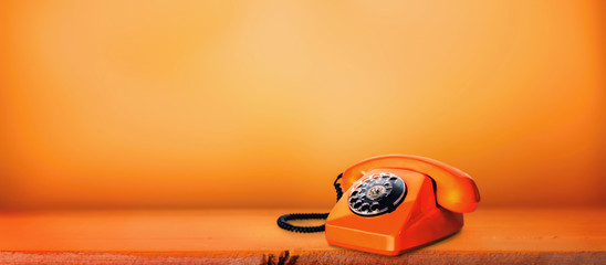 Orange phone on an orange background