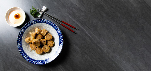 (Hoi Jo or Hai Choe) Deep Fried Crab Meat Rolls. Chinese Traditional cuisine concept. Dumplings Dim Sum in bamboo steamer with text copy space. Asian food background