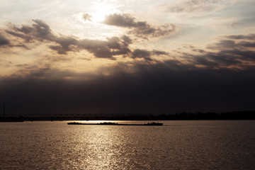 Obraz premium Tanker ship on the river Danube at Sunset in Belgrade, Serbia with beautiful dramatic sky and amazing clouds