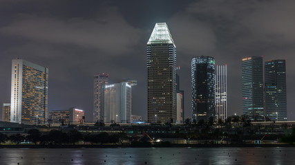 Fototapeta premium Downtown skyline of Singapore as viewed from across the water from The Garden East night timelapse. Singapore.